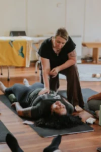 Kath Whitehorn providing a Spinal Energetics session with a client resting face down on a treatment table at Hill Tribe Healing.