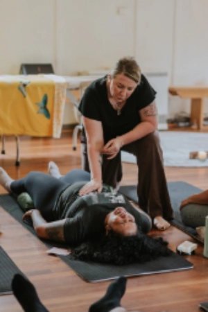Kath Whitehorn providing a Spinal Energetics session with a client resting face down on a treatment table at Hill Tribe Healing.