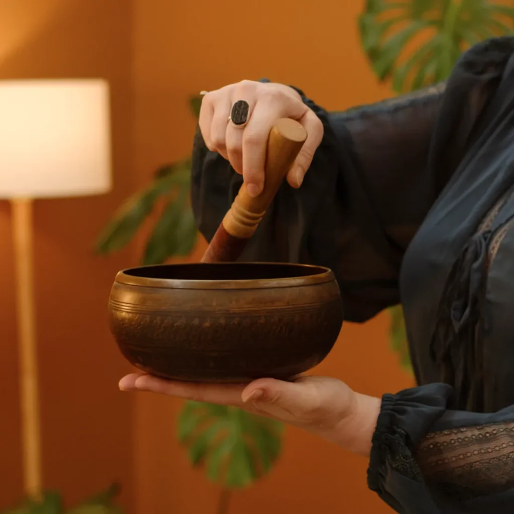 Hands holding a singing bowl